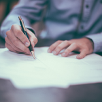 What Is Bridging Finance & How Does It Work & Is It A Risk? Signing paperwork - What is bridging finance small